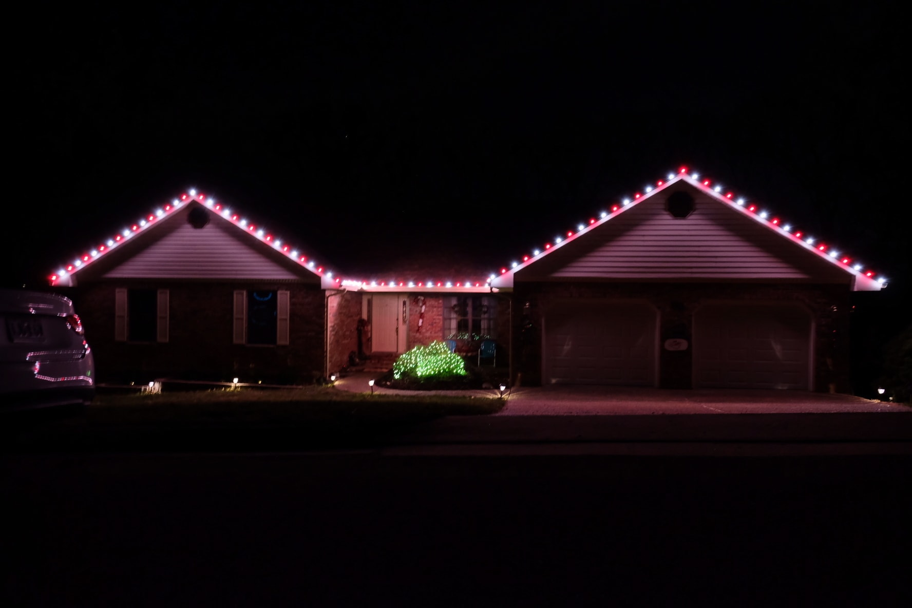Precise roofline and eave holiday lighting on home