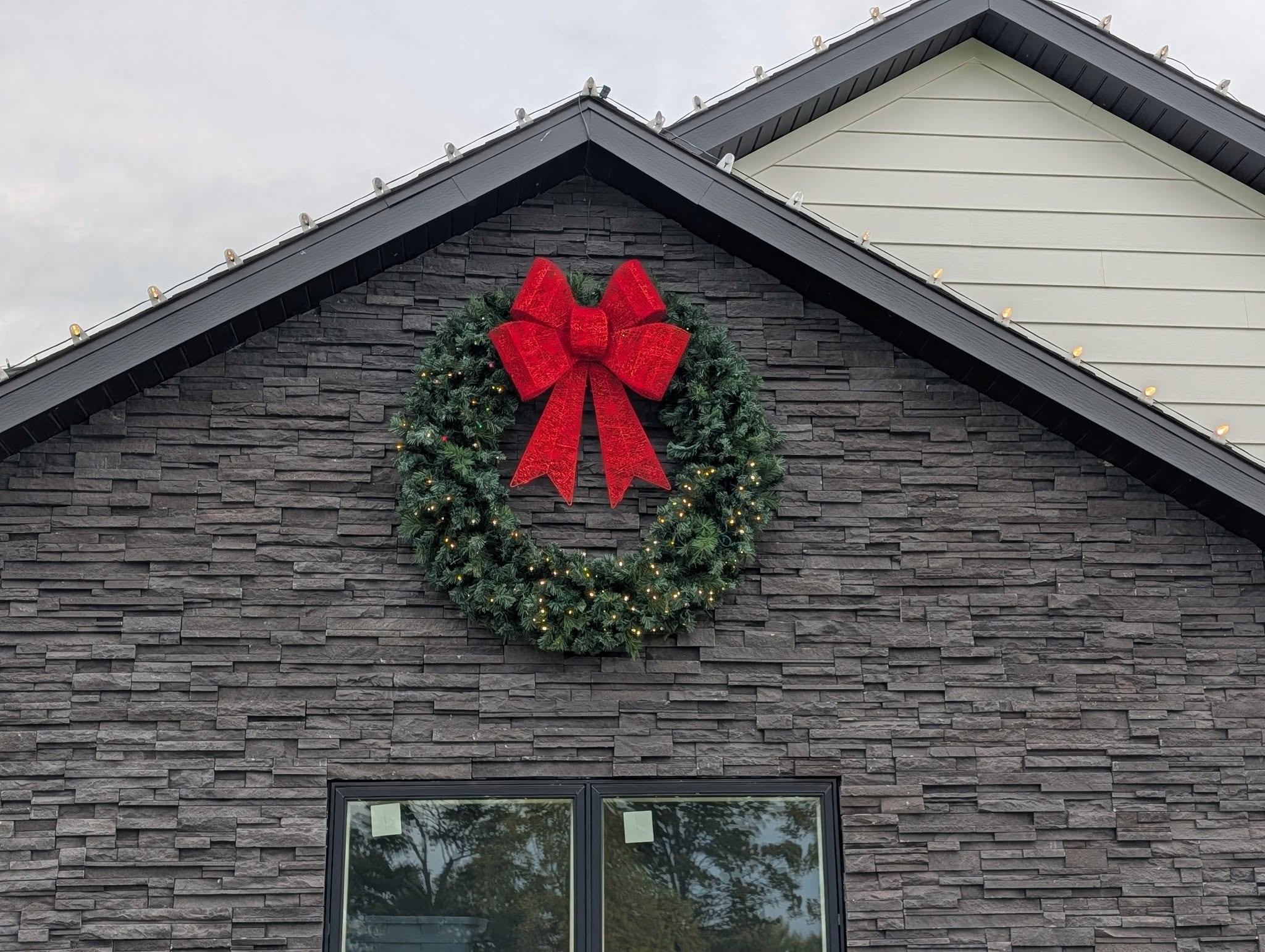 Roofline holiday lighting on home exterior