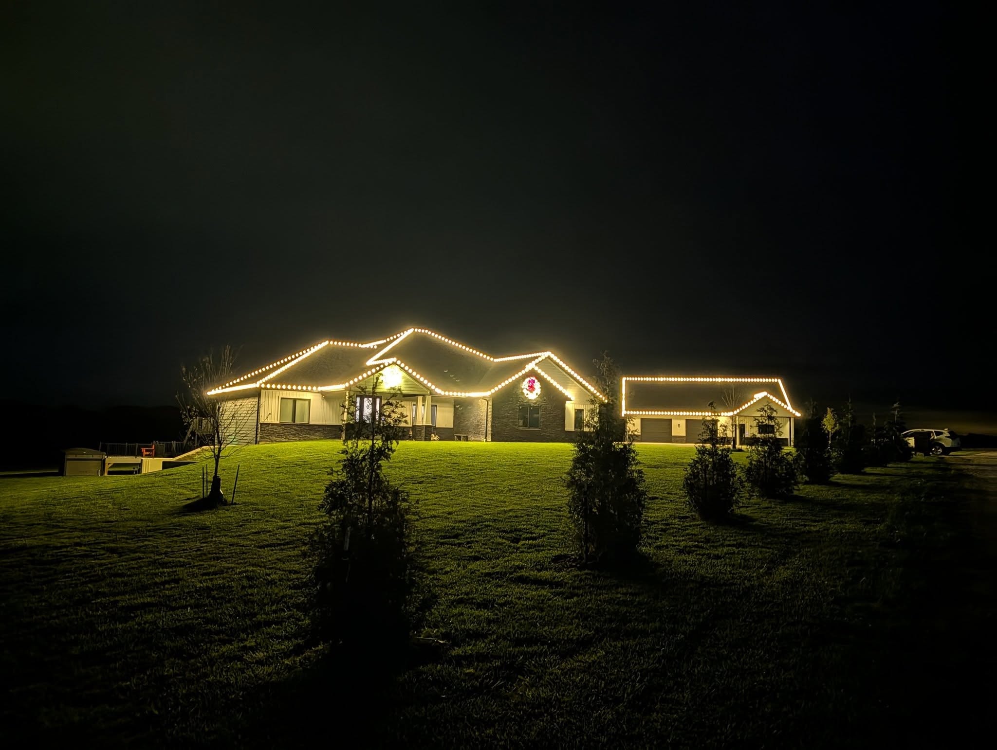 Classic white holiday lights on home roofline and eaves