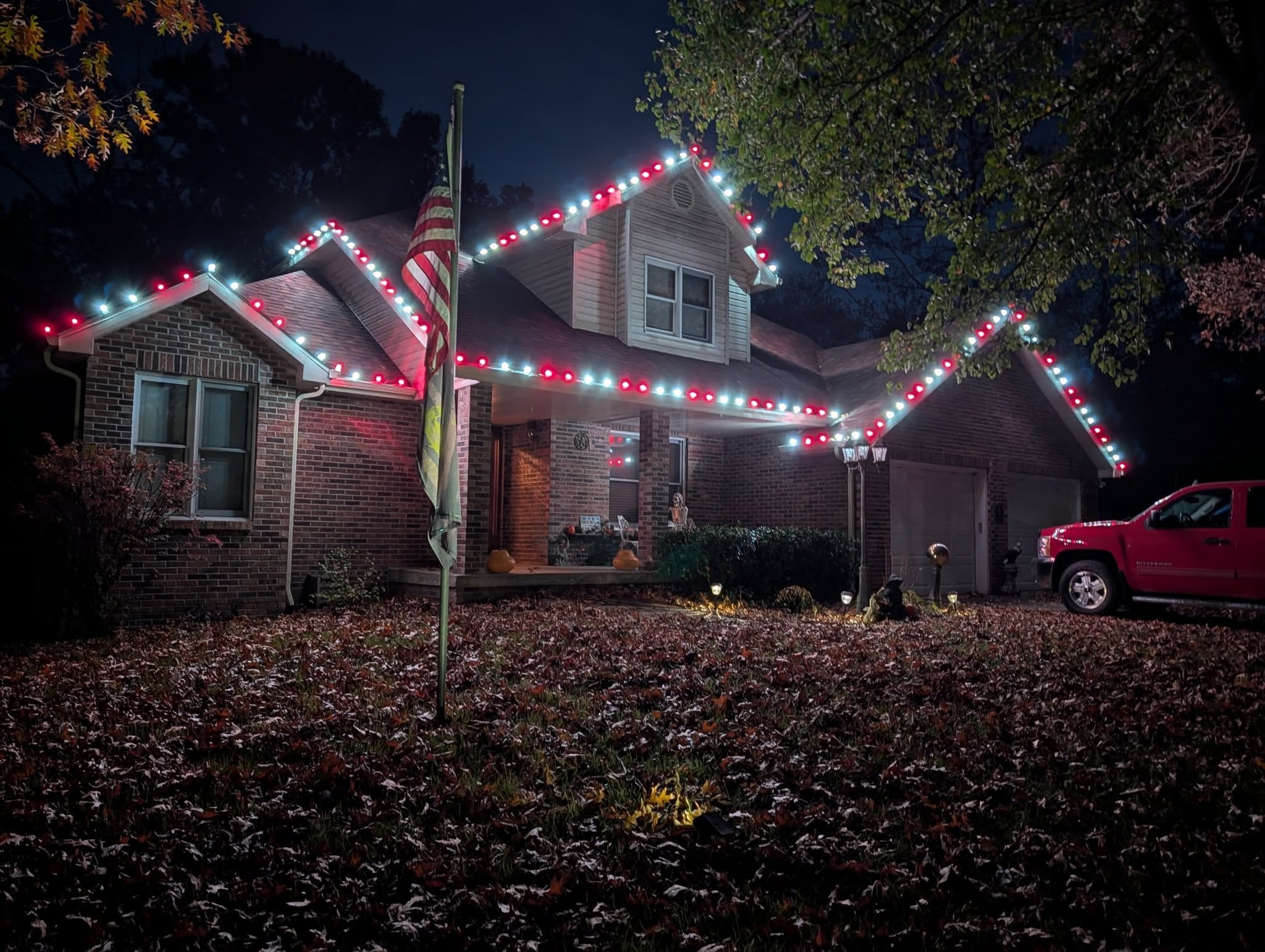 Festive roofline holiday lighting on home