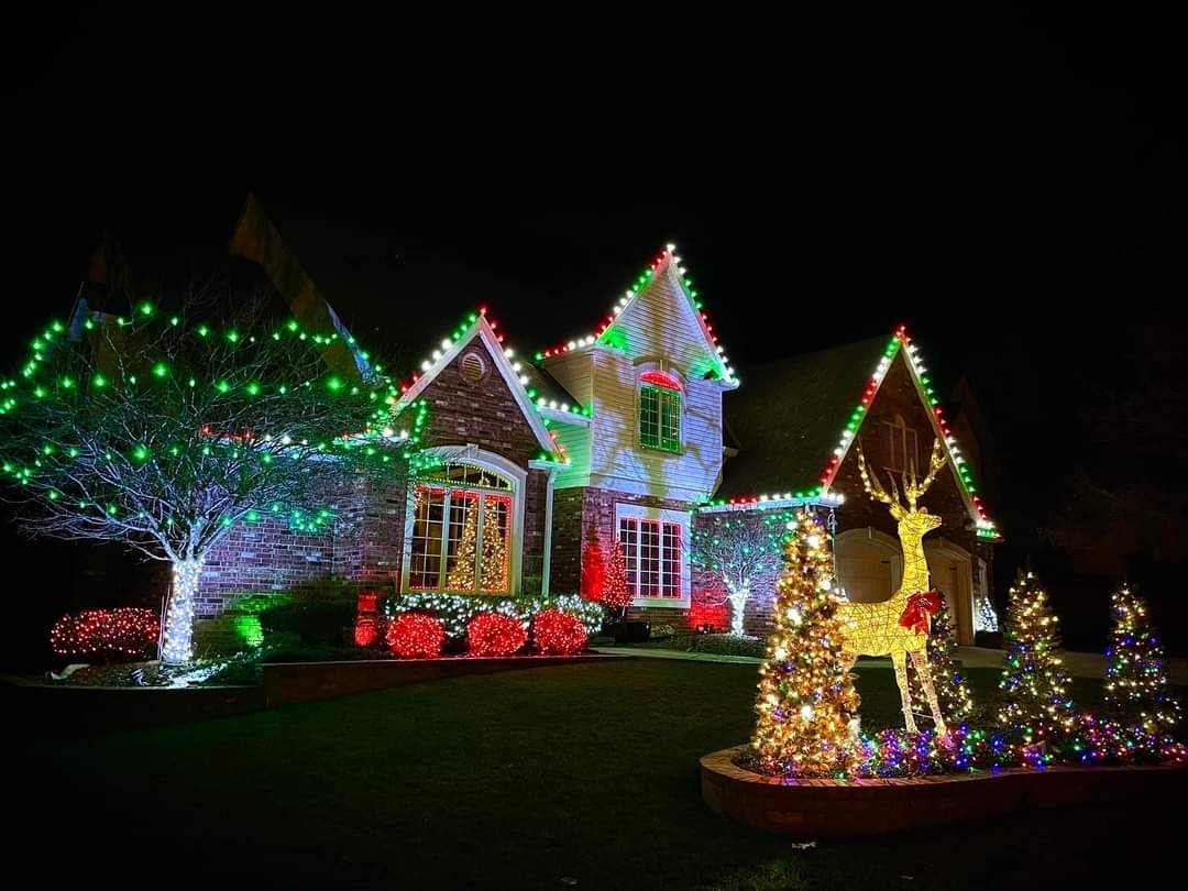 Home with colorful multicolor holiday lights on roofline and trees