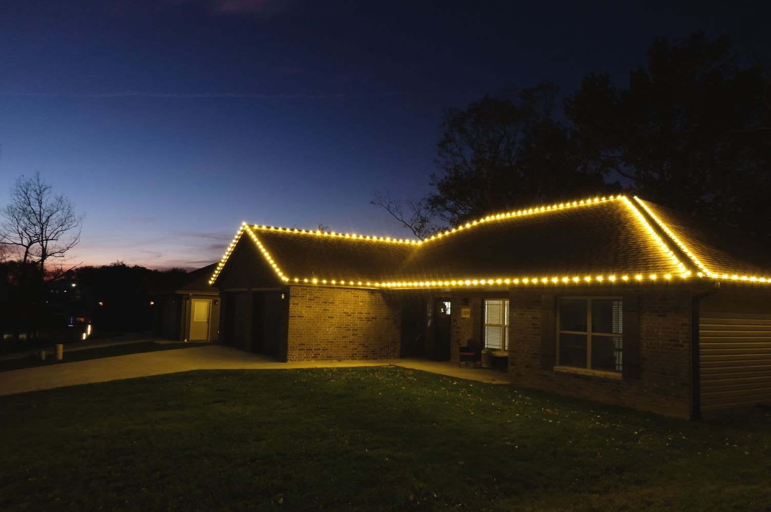 Elegant warm white holiday lights on home roofline
