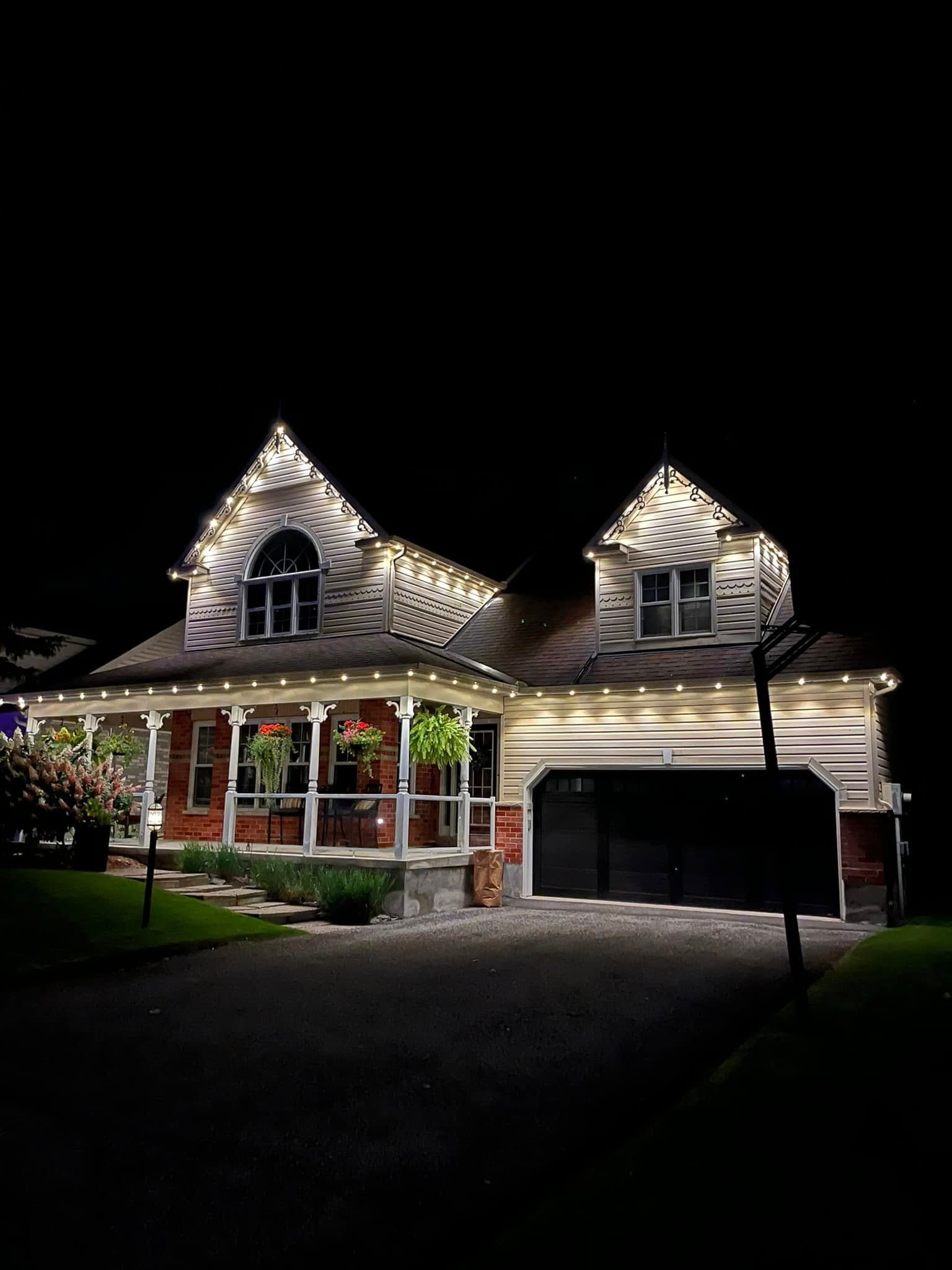 Victorian style home with permanent warm white roofline LED lighting at night