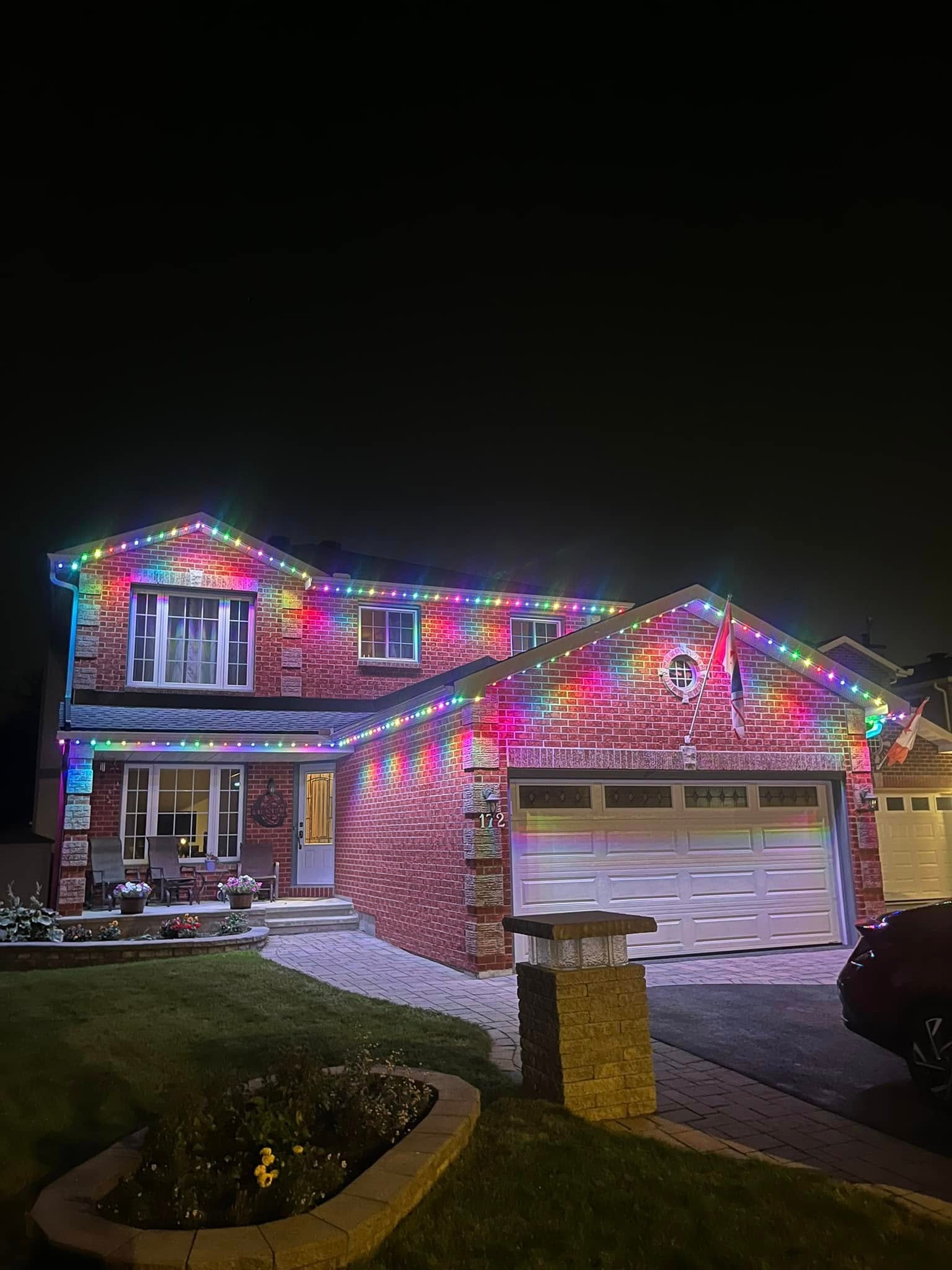Home with permanent RGB full color roofline LED lighting at night