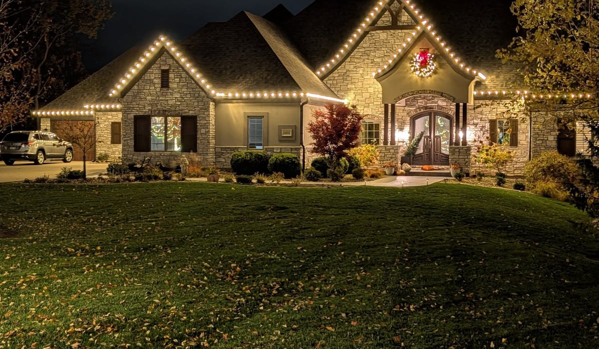House decorated with professional holiday lights at night