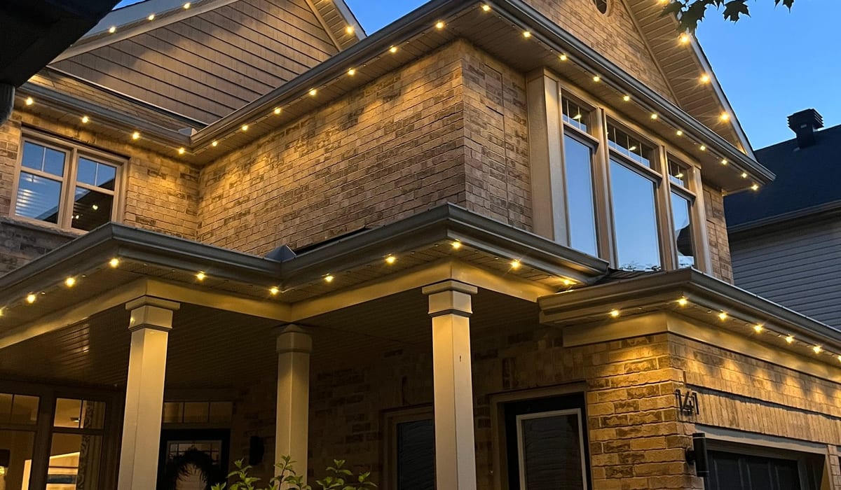 Permanent LED architectural lighting on home roofline at night